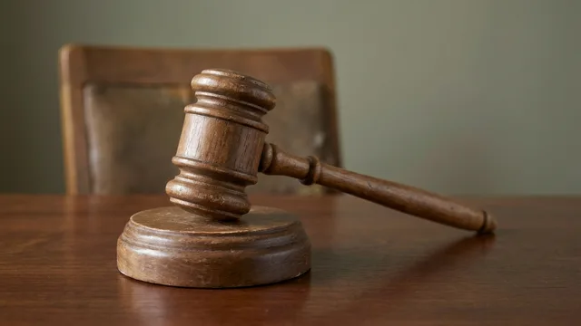 AI-generated illustration of a wooden gavel and sound block on an empty desk.